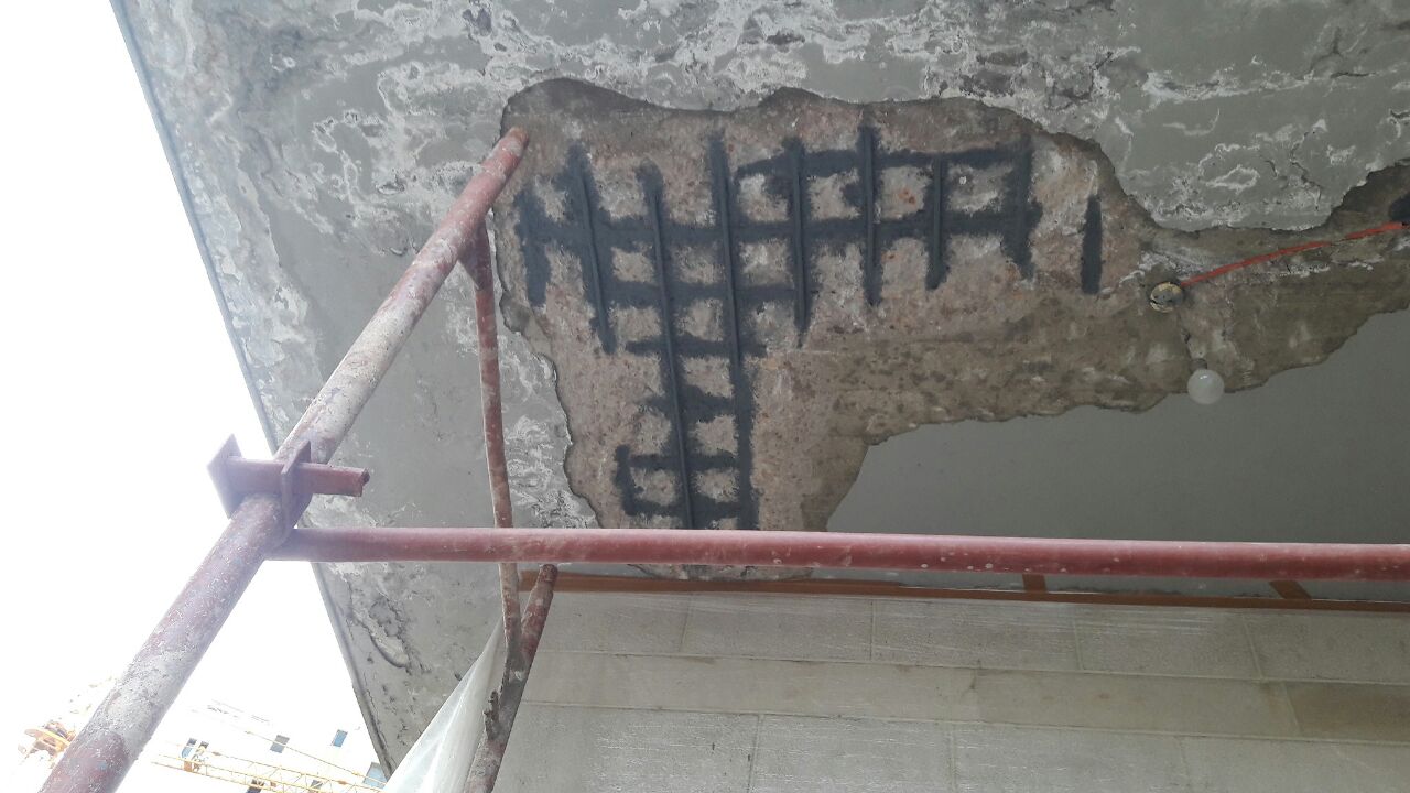 Exposed rebar on interior ceiling with scaffolding