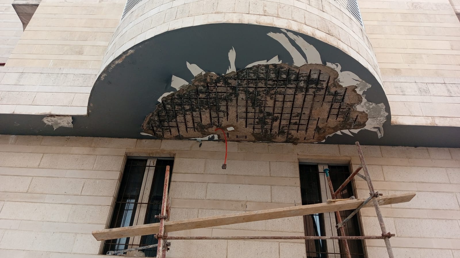 Exposed rebar on the exterior facade of Saint Ephrem Church